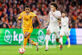 2022-09-25 - Cody Gakpo of The Netherlands, Axel Witsel of Belgium during the UEFA Nations League, League A Group 4, football match between Netherlands and Belgium on September 25, 2022 at Johan Cruijff ArenA in Amsterdam, Netherlands - FOOTBALL - NATIONS LEAGUE - NETHERLANDS V BELGIUM - UEFA NATIONS LEAGUE - SOCCER