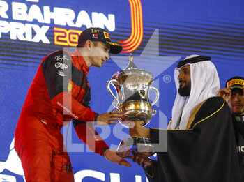 2022-03-20 - LECLERC Charles (mco), Scuderia Ferrari F1-75, portrait celebrates his victory on podium during the Formula 1 Gulf Air Bahrain Grand Prix 2022, 1st round of the 2022 FIA Formula One World Championship, on the Bahrain International Circuit, from March 18 to 20, 2022 in Sakhir, Bahrain - FORMULA 1 GULF AIR BAHRAIN GRAND PRIX 2022, 1ST ROUND OF THE 2022 FIA FORMULA ONE WORLD CHAMPIONSHIP - FORMULA 1 - MOTORS
