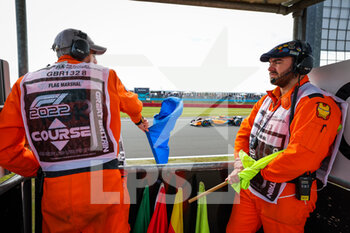2022-07-01 - Marshals watching the cars during the Formula 1 Lenovo British Grand Prix 2022, 10th round of the 2022 FIA Formula One World Championship, on the Silverstone Circuit, from July 1 to 3, 2022 in Silverstone, United Kingdom - F1 - BRITISH GRAND PRIX 2022 - FORMULA 1 - MOTORS