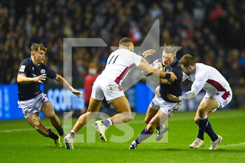 2022-02-05 - Scotland Captain, Stuart Hogg is tackled by England's Joe Merchant and England's Elliot Daly during the Six Nations 2022 rugby union match between Scotland and England on February 5, 2022 at BT Murrayfield in Edinburgh, Scotland - SIX NATIONS 2022 - SCOTLAND VS ENGLAND - SIX NATIONS - RUGBY