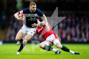 2022-02-12 - Finn Russell of Scotland is tackled by Ross Moriarty of Wales during the Six Nations 2022, rugby union match between Wales and Scotland on February 12, 2022 at Principality Stadium in Cardiff, Wales - SIX NATIONS 2022 - WALES VS SCOTLAND - SIX NATIONS - RUGBY