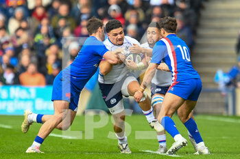 2022-02-26 - Scotland's Sione Tuipulotu is tackled by France's Damian Penaud and France's Romain Ntamack during the Six Nations 2022, rugby union match between Scotland and France on February 26, 2022 at BT Murrayfield Stadium in Edinburgh, Scotland - SIX NATIONS 2022 - SCOTLAND VS FRANCE - SIX NATIONS - RUGBY