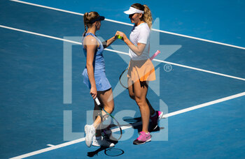 2022-01-24 - Marta Kostyuk of Ukraine & Dayana Yastremska of Ukraine in action during the third round of doubles at the 2022 Australian Open, WTA Grand Slam tennis tournament on January 24, 2022 at Melbourne Park in Melbourne, Australia - 2022 AUSTRALIAN OPEN, WTA GRAND SLAM TENNIS TOURNAMENT - INTERNATIONALS - TENNIS