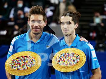 2022-02-06 - Nicolas Mahut and Pierre-Hughes Herbert of France celebrate with the winners trophies after winning the Double final of the Open Sud de Fance 2022, ATP 250 tennis tournament on February 6, 2022 at Sud de France Arena in Montpellier France - OPEN SUD DE FRANCE 2022, ATP 250 TENNIS TOURNAMENT - INTERNATIONALS - TENNIS