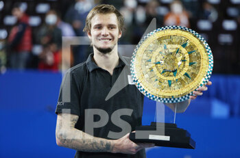 2022-02-06 - Alexander Bublik of Kazakhstan celebrates with the trophy after winning against Alexander Zverev of Germany during the final of the Open Sud de France 2022, ATP 250 tennis tournament on February 6, 2022 at Sud de France Arena in Montpellier, France - OPEN SUD DE FRANCE 2022, ATP 250 TENNIS TOURNAMENT - INTERNATIONALS - TENNIS