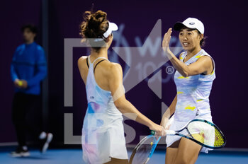 2022-02-23 - Ena Shibahara of Japan & Shuai Zhang of China in action during the doubles quarter-final of the 2022 Qatar TotalEnergies Open, WTA 1000 tennis tournament on February 23, 2022 at Khalifa tennis and squash complex in Doha, Qatar - 2022 QATAR TOTALENERGIES OPEN, WTA 1000 TENNIS TOURNAMENT - INTERNATIONALS - TENNIS