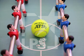2022-03-24 - Official tennis ball and baby foot during the Play In Challenger 2022, ATP Challenger Tour tennis tournament on March 24, 2022 at Tennis Club Lillois Lille Metropole in Lille, France - PLAY IN CHALLENGER 2022, ATP CHALLENGER TOUR TENNIS TOURNAMEN - INTERNATIONALS - TENNIS