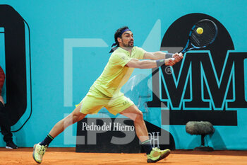 2022-05-01 - Fabio Fognini from Italy in action against Nikoloz Basilashvili from Georgia during the Mutua Madrid Open 2022 tennis tournament on May 2, 2022 at Caja Magica stadium in Madrid, Spain - MUTUA MADRID OPEN 2022 TENNIS TOURNAMENT - INTERNATIONALS - TENNIS