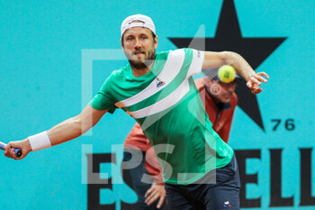 2022-05-02 - Lucas Pouille from France in action against Karen Khachanov from Russia during the Mutua Madrid Open 2022 tennis tournament on May 2, 2022 at Caja Magica stadium in Madrid, Spain - MUTUA MADRID OPEN 2022 TENNIS TOURNAMENT - INTERNATIONALS - TENNIS