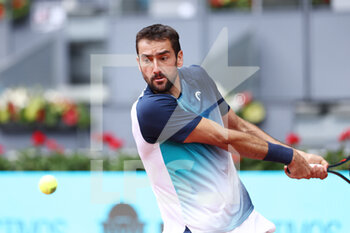 2022-05-04 - Marin Cilic of Croatia in action against Alexander Zverev of Germany during the Mutua Madrid Open 2022 tennis tournament on May 4, 2022 at Caja Magica stadium in Madrid, Spain - MUTUA MADRID OPEN 2022 TENNIS TOURNAMENT - INTERNATIONALS - TENNIS