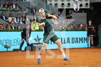 2022-05-04 - Miomir Kecmanovic of Serbia in action against Rafael Nadal of Spain during the Mutua Madrid Open 2022 tennis tournament on May 4, 2022 at Caja Magica stadium in Madrid, Spain - MUTUA MADRID OPEN 2022 TENNIS TOURNAMENT - INTERNATIONALS - TENNIS