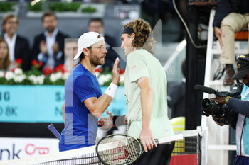 2022-05-04 - Stefanos Tsitsipas of Greece and Lucas Pouille of France during the Mutua Madrid Open 2022 tennis tournament on May 4, 2022 at Caja Magica stadium in Madrid, Spain - MUTUA MADRID OPEN 2022 TENNIS TOURNAMENT - INTERNATIONALS - TENNIS
