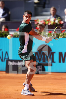 2022-05-06 - Carlos Alcaraz of Spain in action against Rafael Nadal of Spain during the Mutua Madrid Open 2022 tennis tournament on May 6, 2022 at Caja Magica stadium in Madrid, Spain - MUTUA MADRID OPEN 2022 TENNIS TOURNAMENT - INTERNATIONALS - TENNIS