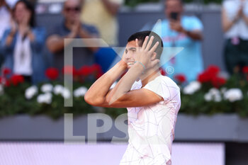 2022-05-06 - Carlos Alcaraz of Spain reacts after winning against Rafael Nadal of Spain during the Mutua Madrid Open 2022 tennis tournament on May 6, 2022 at Caja Magica stadium in Madrid, Spain - MUTUA MADRID OPEN 2022 TENNIS TOURNAMENT - INTERNATIONALS - TENNIS