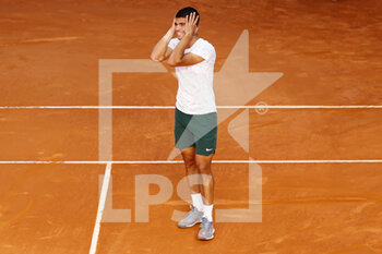 2022-05-06 - Carlos Alcaraz of Spain reacts after winning against Rafael Nadal of Spain during the Mutua Madrid Open 2022 tennis tournament on May 6, 2022 at Caja Magica stadium in Madrid, Spain - MUTUA MADRID OPEN 2022 TENNIS TOURNAMENT - INTERNATIONALS - TENNIS