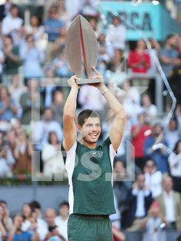 2022-05-08 - Carlos Alcaraz of Spain celebrates with the champion trophy after winning against Alexander Zverev of Germany, Final Men's ATP match during the Mutua Madrid Open 2022 tennis tournament on May 8, 2022 at Caja Magica stadium in Madrid, Spain - MUTUA MADRID OPEN 2022 TENNIS TOURNAMENT - INTERNATIONALS - TENNIS
