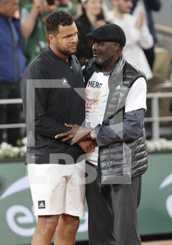 2022-05-24 - Jo-Wilfried Tsonga of France, his father Didier Tsonga during a ceremony celebrating his career after his last tennis match against Casper Ruud of Norway on day 3 of the French Open 2022, a tennis Grand Slam tournament on May 24, 2022 at Roland-Garros stadium in Paris, France - ROLAND-GARROS 2022, FRENCH OPEN 2022, GRAND SLAM TENNIS TOURNAMENT - INTERNATIONALS - TENNIS