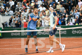 2022-05-25 - Borna Coric of Croatia and Grigor Dimitrov of Bulgaria shake hands at the net during the French Open, Grand Slam tennis tournament on May 25, 2022 at Roland-Garros stadium in Paris, France - ROLAND-GARROS 2022, FRENCH OPEN 2022, GRAND SLAM TENNIS TOURNAMENT - INTERNATIONALS - TENNIS