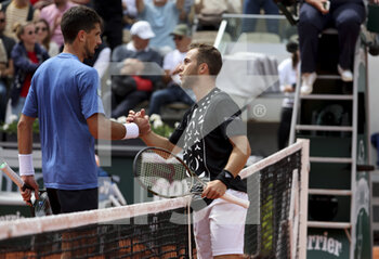 2022-05-26 - Hugo Gaston of France shakes hands with Pedro Cachín of Argentina (left) after his victory during day 5 of the French Open 2022, Roland-Garros 2022, second Grand Slam tennis tournament of the season on May 26, 2022 at Roland-Garros stadium in Paris, France - TENNIS - ROLAND GARROS 2022 - WEEK 1 PART 2 - INTERNATIONALS - TENNIS