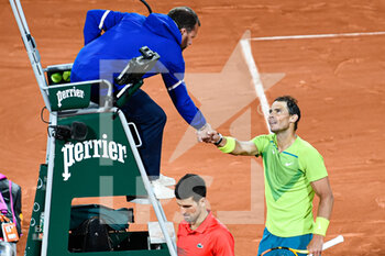 2022-06-01 - Rafael Nadal of Spain and Novak Djokovic of Serbia shake hands during the French Open semifinal, Grand Slam tennis tournament on May 31, 2022 at Roland-Garros stadium in Paris, France - TENNIS - ROLAND GARROS 2022 - WEEK 2 - INTERNATIONALS - TENNIS