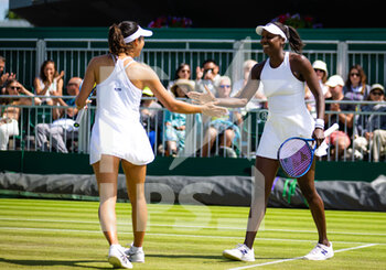 2022-07-04 - Ena Shibahara of Japan & Asia Muhammad of the United States in action during the third round of doubles at the 2022 Wimbledon Championships, Grand Slam tennis tournament on July 4, 2022 at All England Lawn Tennis Club in Wimbledon near London, England - TENNIS - WIMBLEDON 2022 - INTERNATIONALS - TENNIS