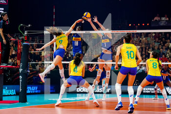 2022-10-13 - Rosamaria Montibeller of Brazil tips the ball while Paola Ogechi Egonu of Italy and Marina Lubian of Italy form a block during the FIVB Volleyball Women's World Championship 2022, Semi Final Volleyball match between Italy and Brazil on October 13, 2022 at the Omnisport Apeldoorn in Apeldoorn, Netherlands - VOLLEYBALL - WOMEN'S WORLD CHAMP 2022 - 1/2 - ITALY V BRAZIL - INTERNATIONALS - VOLLEYBALL