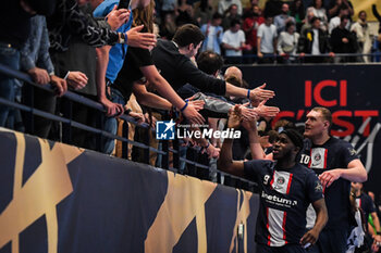 2023-05-17 - Adama KEITA of PSG and Dainis KRISTOPANS of PSG celebrate the victory with supporters during the EHF Champions League, Quarter-finals, 2nd leg handball match between Paris Saint-Germain and THW Kiel on May 17, 2023 at Pierre de Coubertin stadium in Paris, France - HANDBALL - CHAMPIONS LEAGUE - PARIS SG V KIEL - HANDBALL - OTHER SPORTS