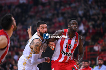 2023-12-05 - 17 Vincent Poirier of Real Madrid competing with 10 Moustapha Fall of Olympiacos Piraeus during the Euroleague, Round 12, match between Olympiacos Piraeus and Real Madrid at Peace and Friendship stadium on December 5, 2023, in Piraeus, Greece. - OLYMPIACOS PIRAEUS VS REAL MADRID - EUROLEAGUE - BASKETBALL