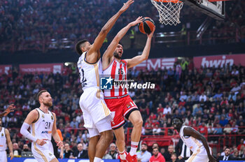 2023-12-05 - 16 Kostas Papanikolaou of Olympiacos Piraeus competing with 22 Walter Tavares of Real Madrid during the Euroleague, Round 12, match between Olympiacos Piraeus and Real Madrid at Peace and Friendship stadium on December 5, 2023, in Piraeus, Greece. - OLYMPIACOS PIRAEUS VS REAL MADRID - EUROLEAGUE - BASKETBALL