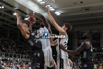 2023-10-15 - Duel under the basket between Devontae Cacok of Virtus Segafredo Bologna and Mattia Udom of Dolomiti Trentino Energia in during the match between Dolomiti Trentino Energia and Virtus Segafredo Bologna, regular season of A1 Italian Basketball Championship 2023/2024 at il T Quotidiano Arena on October 15, 2023, Trento, Italy. - DOLOMITI ENERGIA TRENTINO VS VIRTUS SEGAFREDO BOLOGNA - ITALIAN SERIE A - BASKETBALL