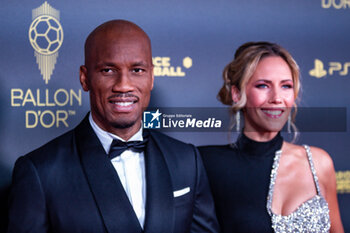 2023-10-30 - Didier Drogba and Sandy Heribert during the red carpet ceremony of the Ballon d'Or (Golden Ball) France Football 2023 on October 30, 2023 at Theatre du Chatelet in Paris, France - FOOTBALL - BALLON D'OR 2023 - RED CARPET CEREMONY - OTHER - SOCCER