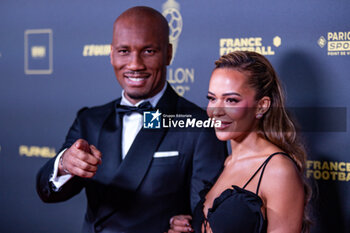 2023-10-30 - Didier Drogba and Gabrielle Lemaire during the red carpet ceremony of the Ballon d'Or (Golden Ball) France Football 2023 on October 30, 2023 at Theatre du Chatelet in Paris, France - FOOTBALL - BALLON D'OR 2023 - RED CARPET CEREMONY - OTHER - SOCCER