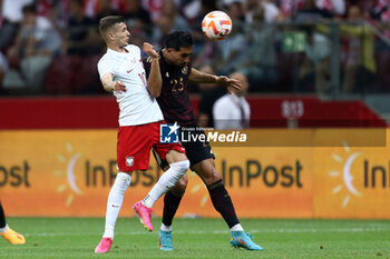 2023-06-16 - Sebastian Szymanski of Poland Emre Can of Germany during the International Friendly Football match between Poland and Germany on June 16, 2023 at PGE Narodowy in Warsaw, Poland - FOOTBALL - FRIENDLY GAME - POLAND V GERMANY - FRIENDLY MATCH - SOCCER