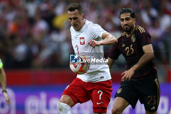 2023-06-16 - Arkadiusz Milik of Poland Emre Can of Germany during the International Friendly Football match between Poland and Germany on June 16, 2023 at PGE Narodowy in Warsaw, Poland - FOOTBALL - FRIENDLY GAME - POLAND V GERMANY - FRIENDLY MATCH - SOCCER