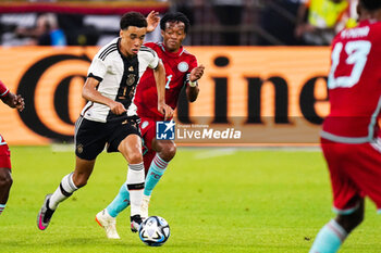 2023-06-20 - Jamal Musiala of Germany battle for possession with Juan Cuadrado of Colombia during the International Friendly football match between Germany and Colombia on June 20, 2023 at the Veltins-Arena in Gelsenkirchen, Germany - FOOTBALL - FRIENDLY GAME - GERMANY V COLOMBIA - FRIENDLY MATCH - SOCCER