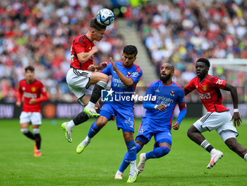 2023-07-19 - Dan Gore of Man Utd wins a header against Mohamed El Arouche of Olympique Lyonnais during the pre-season friendly football match between Manchester United and Olympique Lyonnais (Lyon) on 19 July 2023 at the Scottish Gas Murrayfield Stadium in Edinburgh, Scotland - FOOTBALL - FRIENDLY GAME - MANCHESTER UNITED V LYON - FRIENDLY MATCH - SOCCER