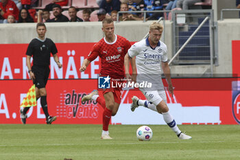2023-08-05 - Josh Doig of Hellas Verona FC battle for the ball with Adrian Beck of FC Heidenheim during FC Heidenheim vs Hellas Verona FC, 11° Max LIEber Cup, at Voith-Arena of Heidenheim, Germany, on August 05, 2023. - FC HEIDENHEIM VS HELLAS VERON - FRIENDLY MATCH - SOCCER