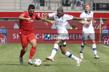 2023-08-05 - Marnon Busch of FC Heidenheim competes for the ball with Jordi Mboula of Hellas Verona FC during FC Heidenheim vs Hellas Verona FC, 11° Max LIEber Cup, at Voith-Arena of Heidenheim, Germany, on August 05, 2023. - FC HEIDENHEIM VS HELLAS VERON - FRIENDLY MATCH - SOCCER