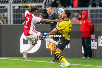 2023-08-06 - Mohammed Kudus of Ajax battles for the ball with Ramy Bensebaini of Borussia Dortmund during the Pre-season Friendly football match between Borussia Dortmund and Ajax on August 6, 2023 at Signal Iduna Park in Dortmund, Germany - FOOTBALL - FRIENDLY GAME - DORTMUND V AJAX - FRIENDLY MATCH - SOCCER