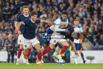 2023-09-12 - Jude Bellingham of England wrestles with Billy Gilmour of Scotland during the 150th Anniversary Heritage Match match between Scotland and England at The National Stadium, 12/09/2023, Hampden Park, Glasgow - FOOTBALL - FRIENDLY GAME - SCOTLAND V ENGLAND - FRIENDLY MATCH - SOCCER