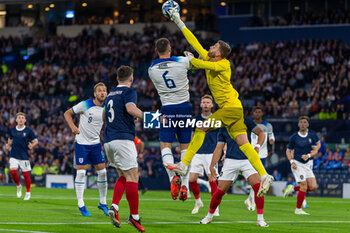2023-09-12 - Angus Gunn of Scotland punches the ball away form Lewis Dunk of England during the 150th Anniversary Heritage Match match between Scotland and England at The National Stadium, 12/09/2023, Hampden Park, Glasgow - FOOTBALL - FRIENDLY GAME - SCOTLAND V ENGLAND - FRIENDLY MATCH - SOCCER