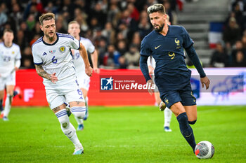 2023-10-17 - Liam COOPER of Scotland and Olivier GIROUD of France during the International Friendly football match between France and Scotland on October 17, 2023 at Pierre Mauroy stadium in Villeneuve-d'Ascq near Lille, France - FOOTBALL - FRIENDLY GAME - FRANCE V SCOTLAND - FRIENDLY MATCH - SOCCER