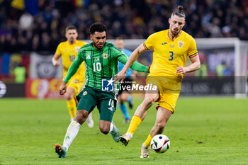 2023-12-11 - Jamie Reid of Northern Ireland and Radu Dragusin of Romania during the International Friendly football match between Romania and Northern Ireland on March 22, 2024 at Arena Nationala in Bucharest, Romania - FOOTBALL - FRIENDLY GAME - ROMANIA V NORTHERN IRELAND - FRIENDLY MATCH - SOCCER