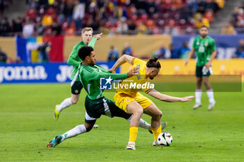 2023-12-11 - Radu Dragusin of Romania and Jamie Reid of Northern Ireland during the International Friendly football match between Romania and Northern Ireland on March 22, 2024 at Arena Nationala in Bucharest, Romania - FOOTBALL - FRIENDLY GAME - ROMANIA V NORTHERN IRELAND - FRIENDLY MATCH - SOCCER