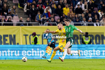 2023-12-11 - George Puscas of Romania and Eoin Toal of Northern Ireland during the International Friendly football match between Romania and Northern Ireland on March 22, 2024 at Arena Nationala in Bucharest, Romania - FOOTBALL - FRIENDLY GAME - ROMANIA V NORTHERN IRELAND - FRIENDLY MATCH - SOCCER