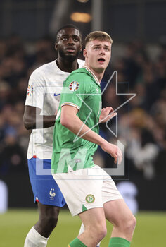 2023-03-27 - Dayot Upamecano of France, Evan Ferguson of Ireland during the UEFA Euro 2024, European Qualifiers, Group B football match between Republic of Ireland and France on March 27, 2023 at Dublin Arena in Dublin, Republic of Ireland - FOOTBALL - EURO 2024 - QUALIFYING - REPUBLIC OF IRELAND V FRANCE - UEFA EUROPEAN - SOCCER