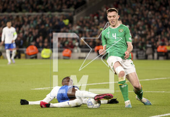 2023-03-27 - Rando Kolo Muani of France, Dara O’Shea of Ireland during the UEFA Euro 2024, European Qualifiers, Group B football match between Republic of Ireland and France on March 27, 2023 at Dublin Arena in Dublin, Republic of Ireland - FOOTBALL - EURO 2024 - QUALIFYING - REPUBLIC OF IRELAND V FRANCE - UEFA EUROPEAN - SOCCER