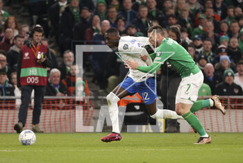 2023-03-27 - Rando Kolo Muani of France, Matthew Doherty of Ireland during the UEFA Euro 2024, European Qualifiers, Group B football match between Republic of Ireland and France on March 27, 2023 at Dublin Arena in Dublin, Republic of Ireland - FOOTBALL - EURO 2024 - QUALIFYING - REPUBLIC OF IRELAND V FRANCE - UEFA EUROPEAN - SOCCER