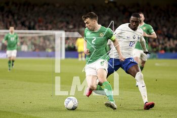 2023-03-27 - Seamus Coleman of Ireland, Rando Kolo Muani of France during the UEFA Euro 2024, European Qualifiers, Group B football match between Republic of Ireland and France on March 27, 2023 at Dublin Arena in Dublin, Republic of Ireland - FOOTBALL - EURO 2024 - QUALIFYING - REPUBLIC OF IRELAND V FRANCE - UEFA EUROPEAN - SOCCER