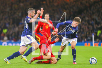 2023-03-28 - Dani Ceballos of Spain and John McGinn, Aaron Hickey of Scotland during the UEFA Euro 2024, European Qualifiers, Group A football match between Scotland and Spain on March 28, 2023 at Hampden Park in Glasgow, Scotland - FOOTBALL - EURO 2024 - QUALIFYING - SCOTLAND V SPAIN - UEFA EUROPEAN - SOCCER